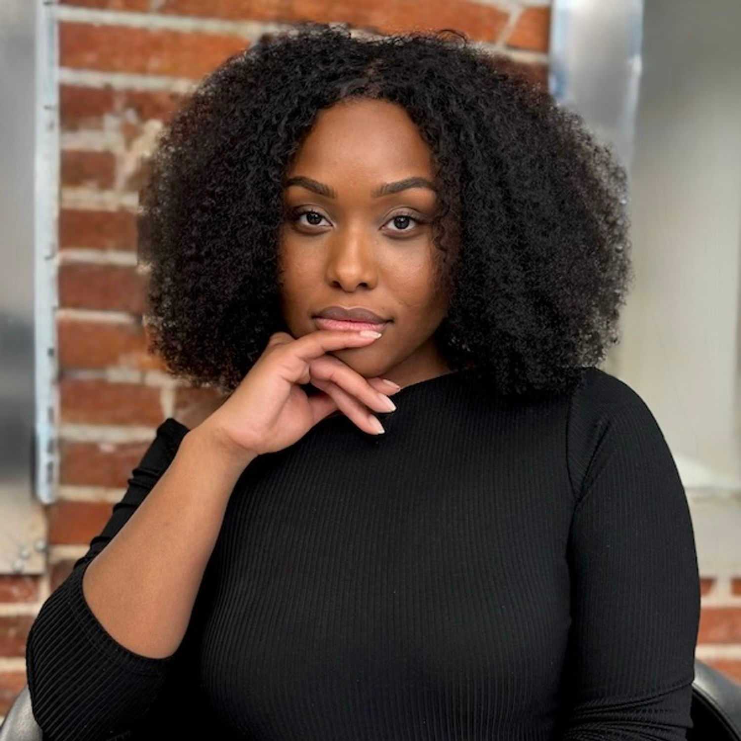 Portrait of Mel Vega, a professional stylist at Cole Stevens Salon, showcasing their expertise and style.