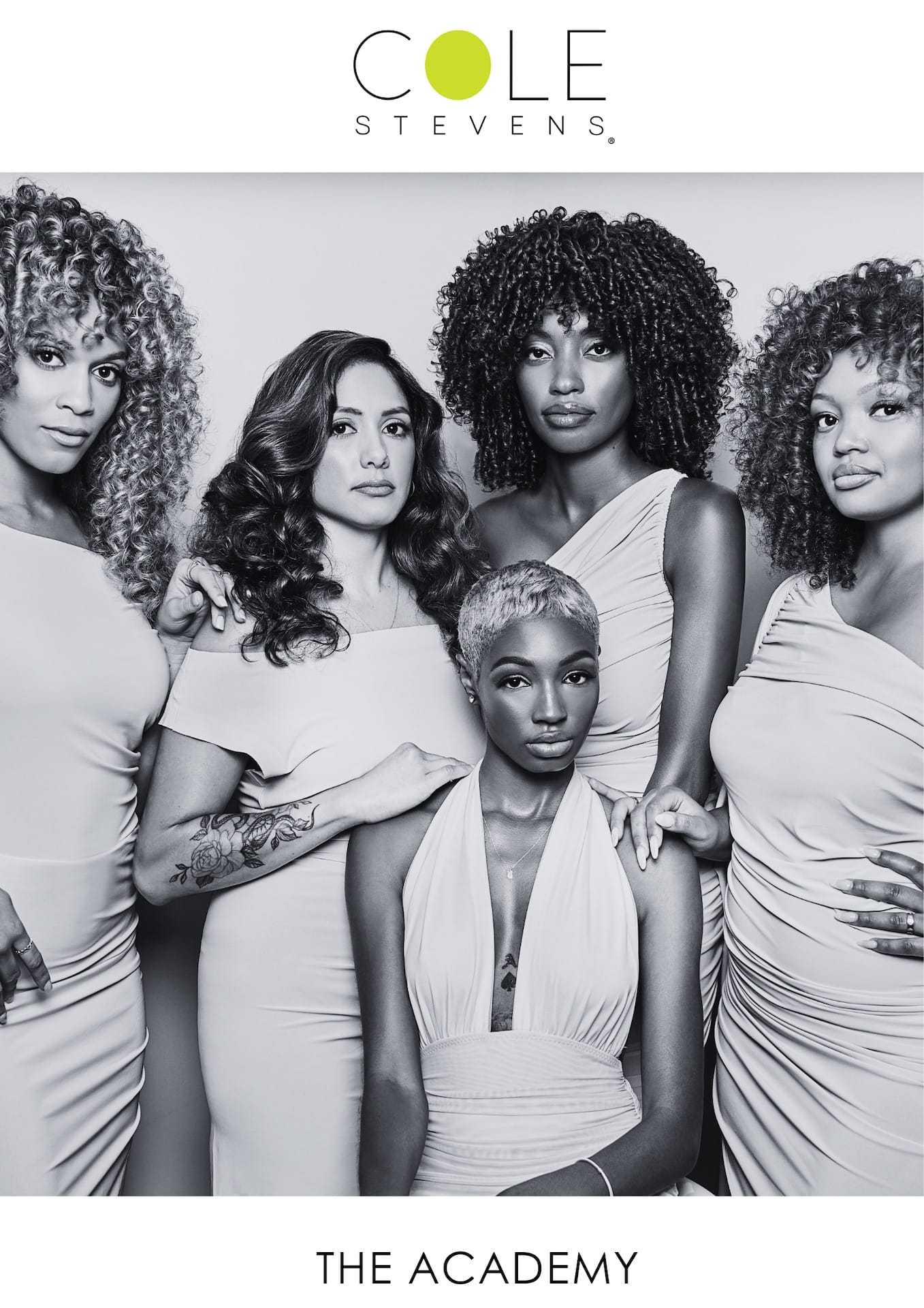 Group of five women posing elegantly in white outfits, featuring diverse hairstyles.